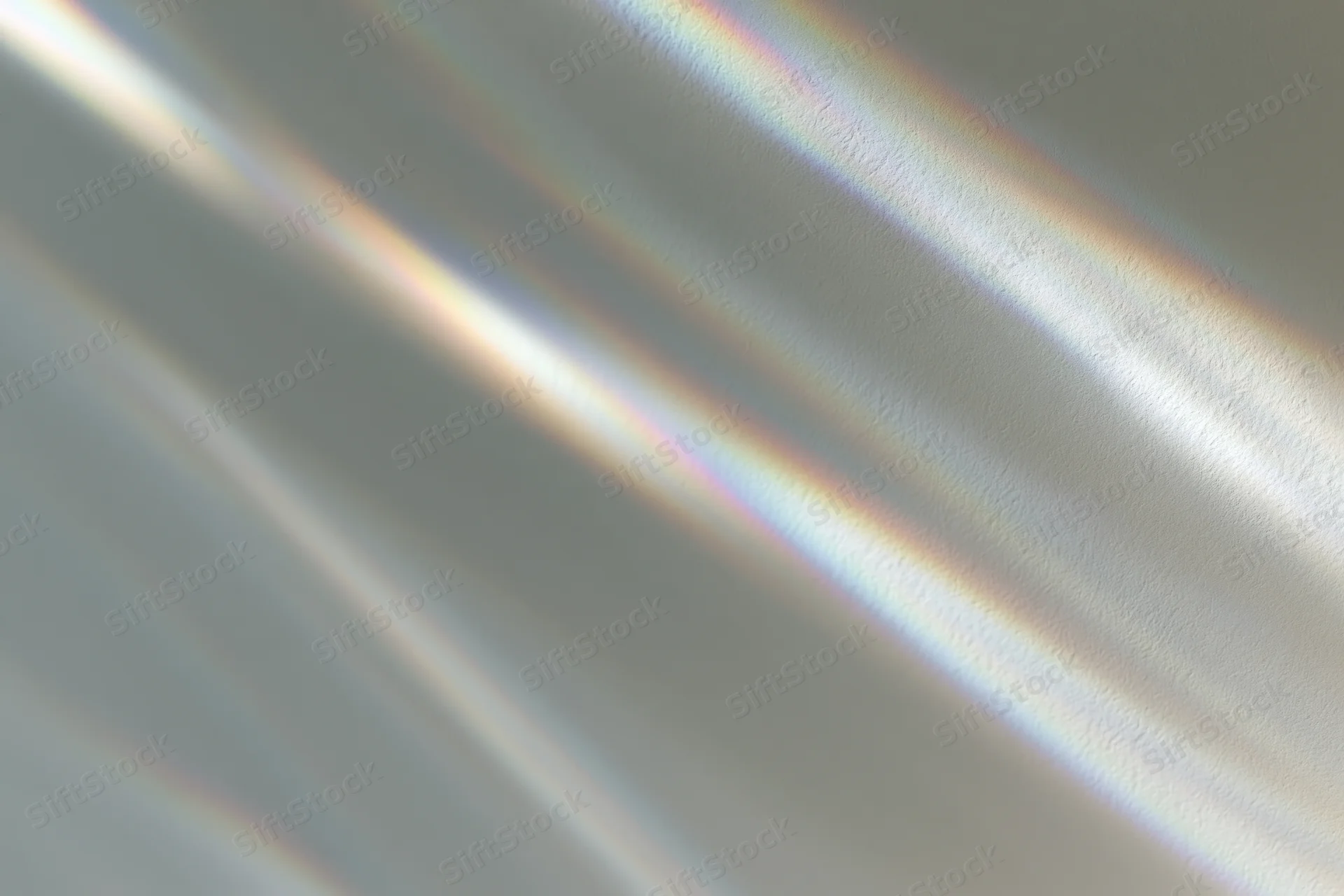 Light refraction creating prismatic rainbow dispersion on a smooth surface