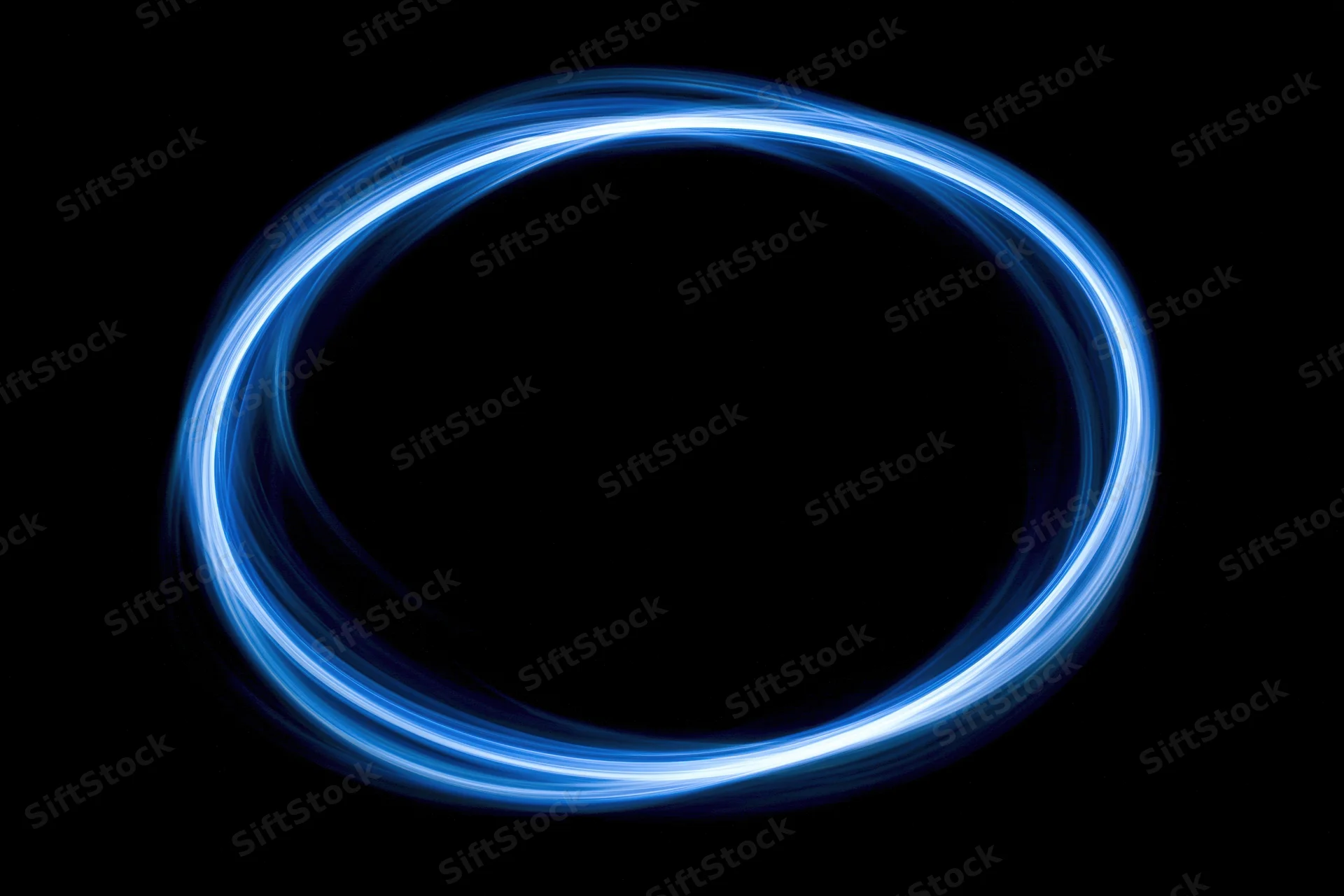 Glowing blue circular light trail formed by long-exposure light painting against black background