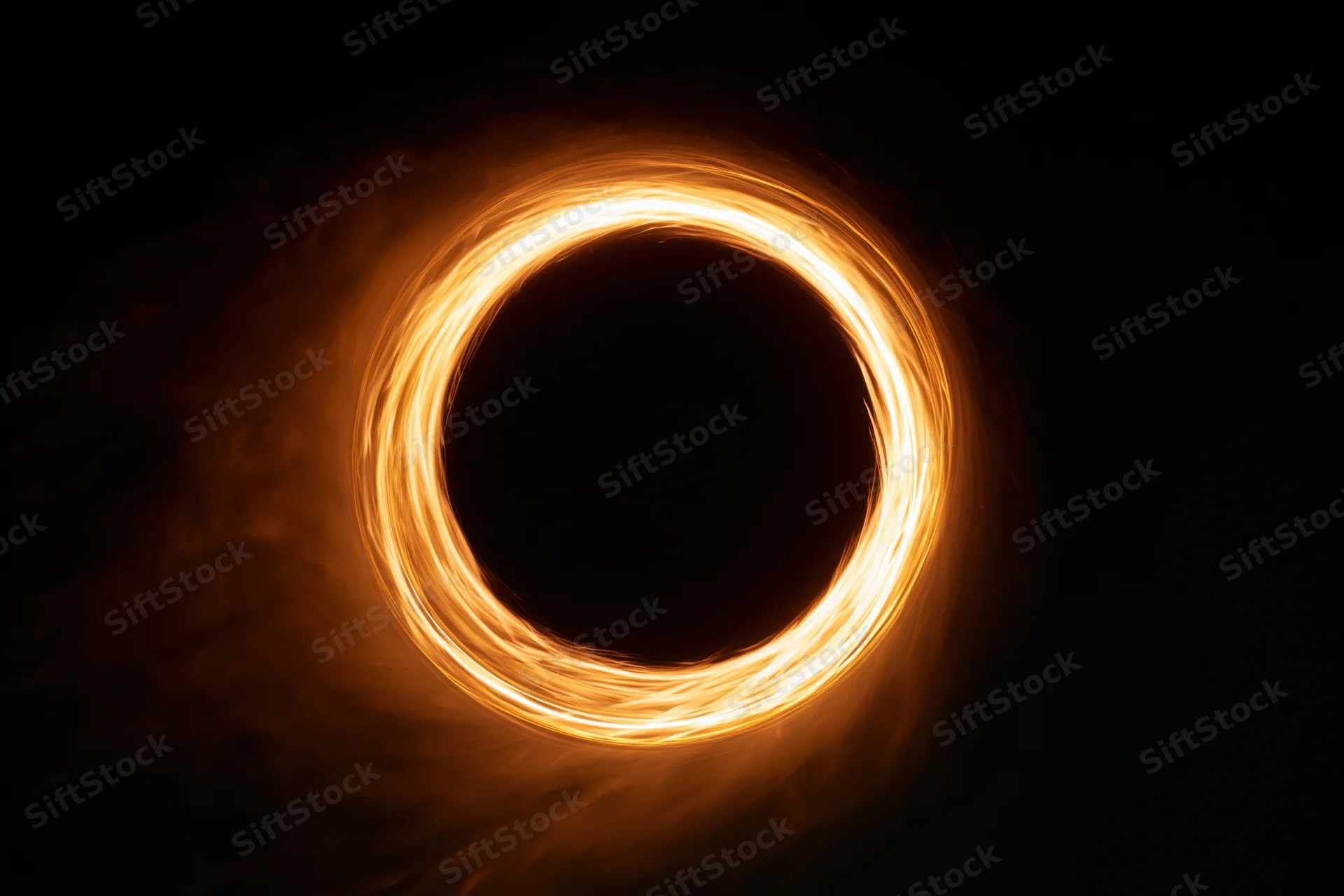 Glowing circular light ring formed by long-exposure light painting against dark background