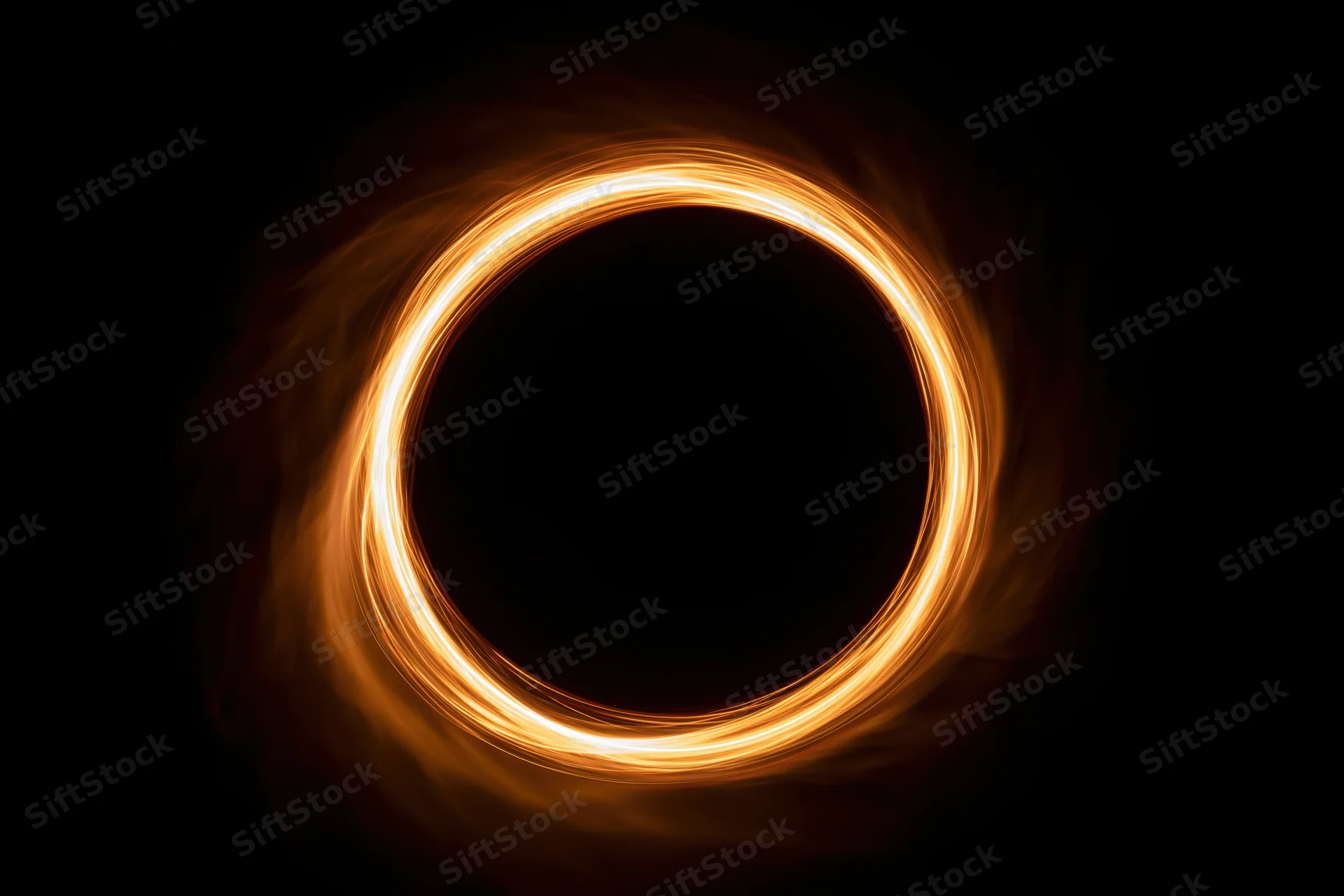 Glowing circular light ring formed by long-exposure light painting against dark background