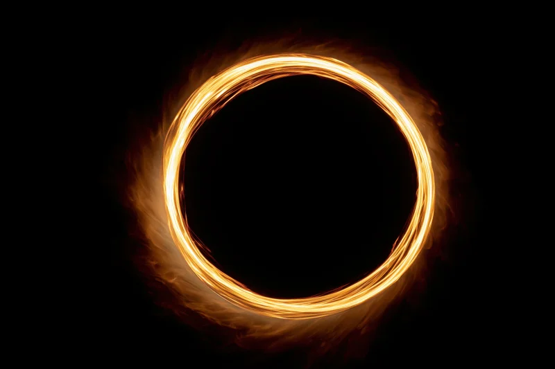 Glowing circular light ring formed by long-exposure light painting against dark background