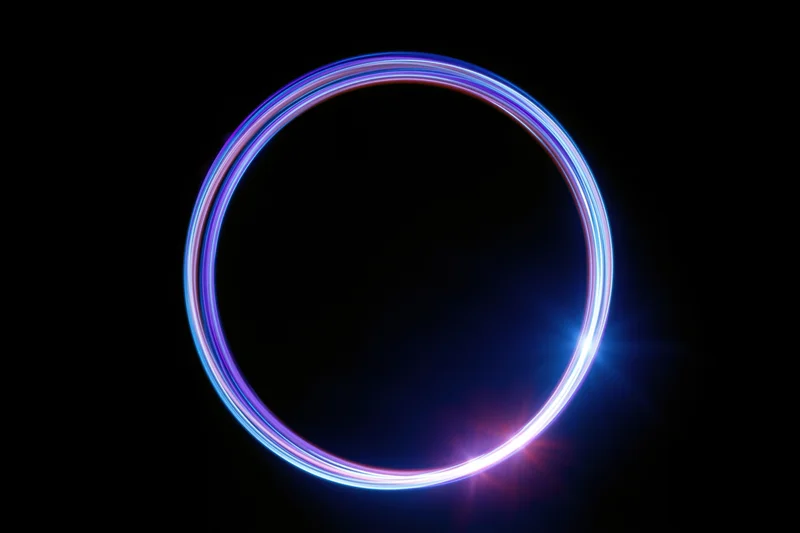 Glowing circular light trail formed by long-exposure light painting against black background