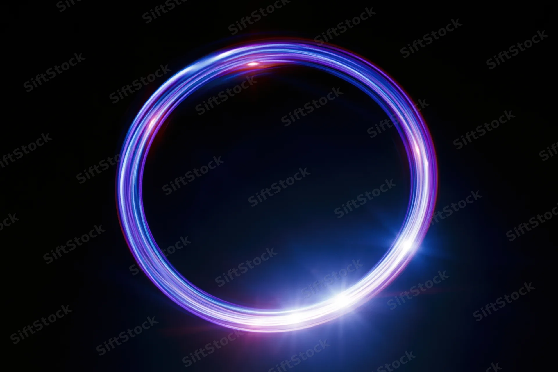 Glowing circular light ring formed by long-exposure light painting against dark background