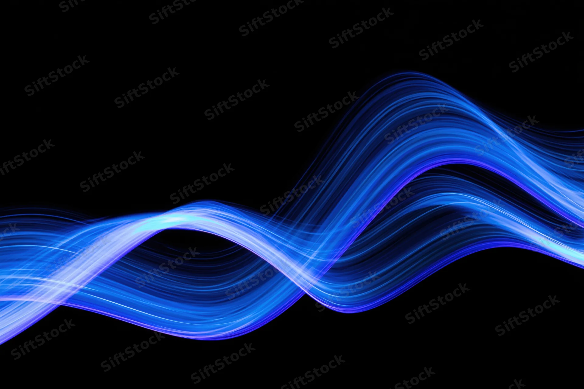 Flowing blue light waves captured in long-exposure light painting photography against black background