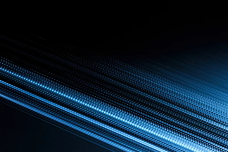 Electric blue light trails moving diagonally across a dark background