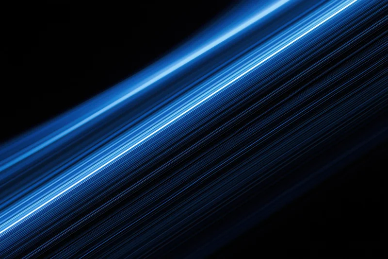 Electric blue light trails moving diagonally across a dark background