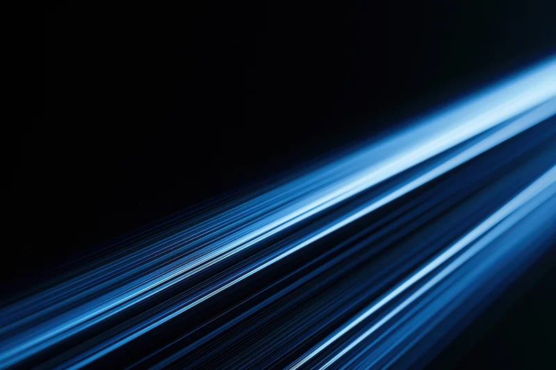 Electric blue light trails streaking diagonally across a dark background