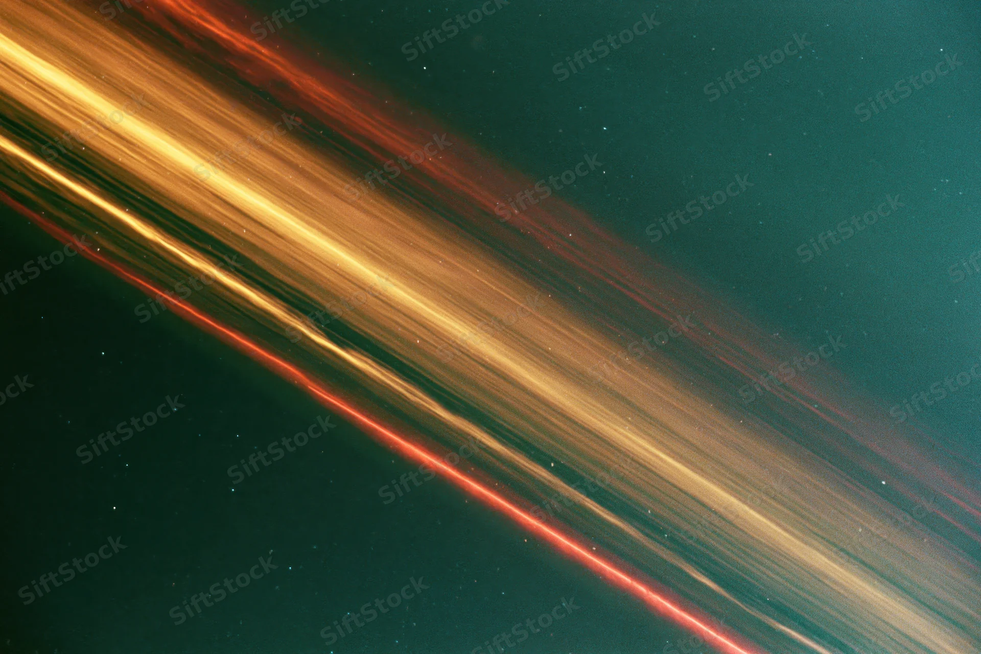 Long-exposure night sky photograph showing sweeping light streaks across dark teal background with scattered stars