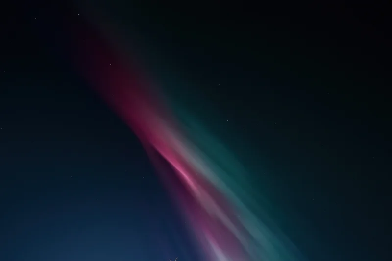 Aurora borealis glowing in streaks across the dark night sky
