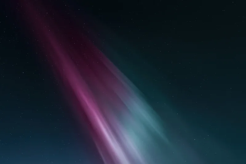 Aurora borealis glowing in the night sky with stars visible above