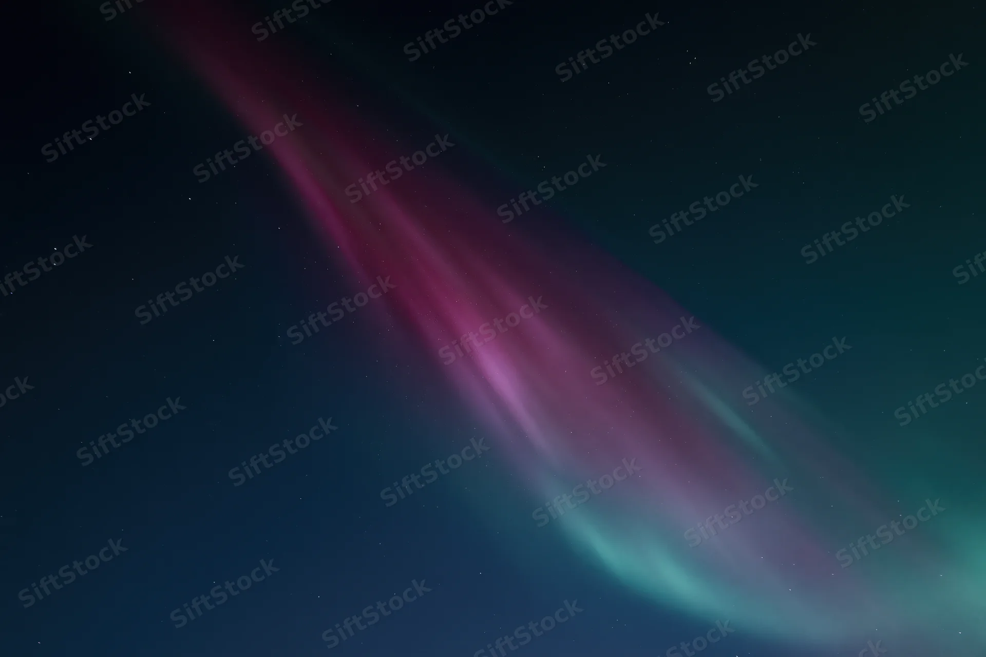 Aurora borealis glowing in night sky with stars and colorful light bands across dark expanse