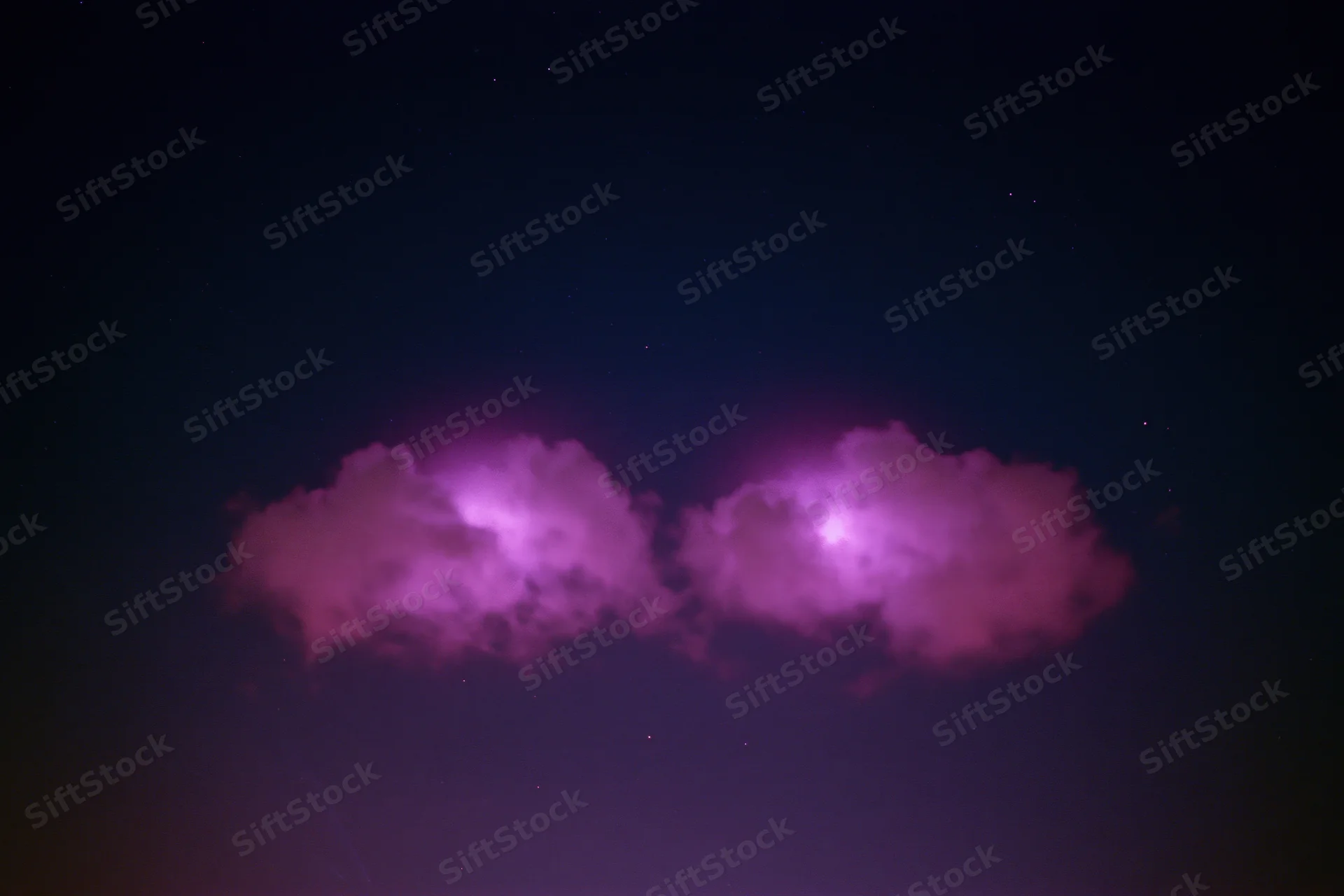 Two glowing magenta-pink cloud formations in the night sky