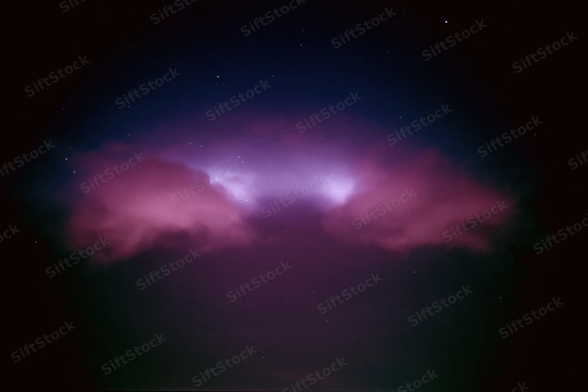 Glowing magenta-pink nebula clouds in dark night sky with scattered stars
