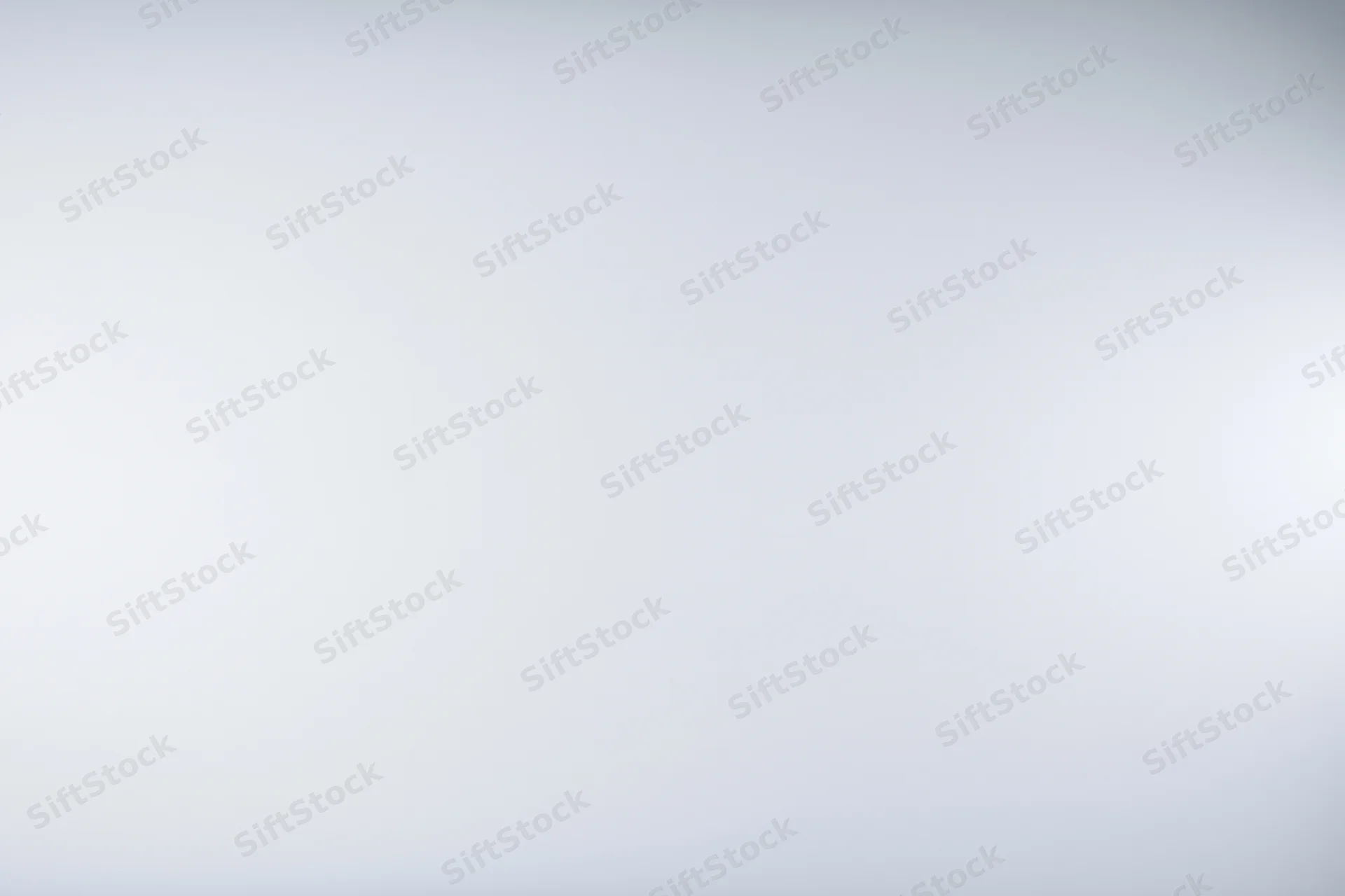 Plain white-grey gradient studio backdrop with soft lighting and copyspace