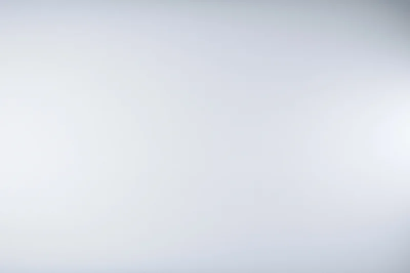 Plain white-grey gradient studio backdrop with soft lighting and copyspace