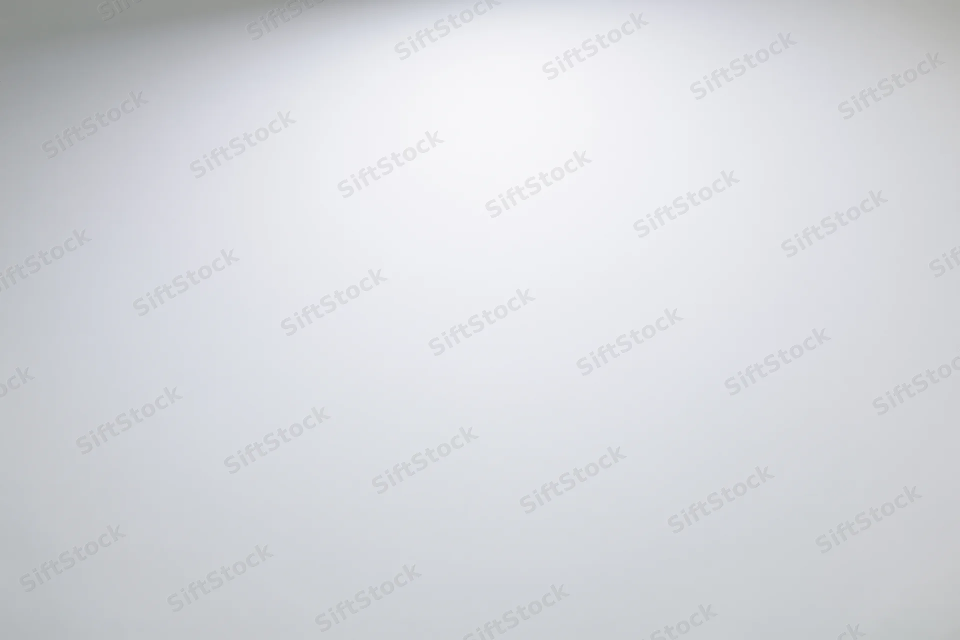Plain white-grey gradient studio backdrop with soft even lighting and copyspace