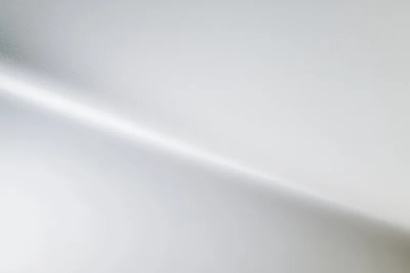 Smooth white-to-grey gradient background in a studio space