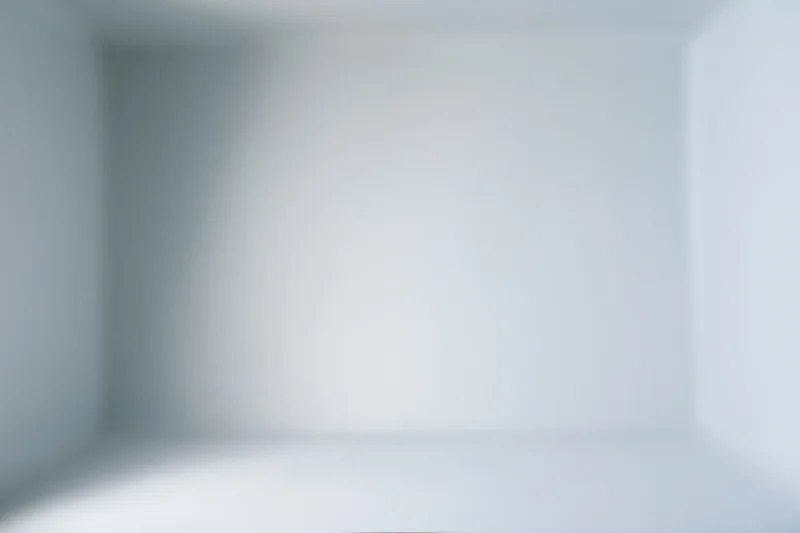 Empty white studio space with gradient lighting for product display