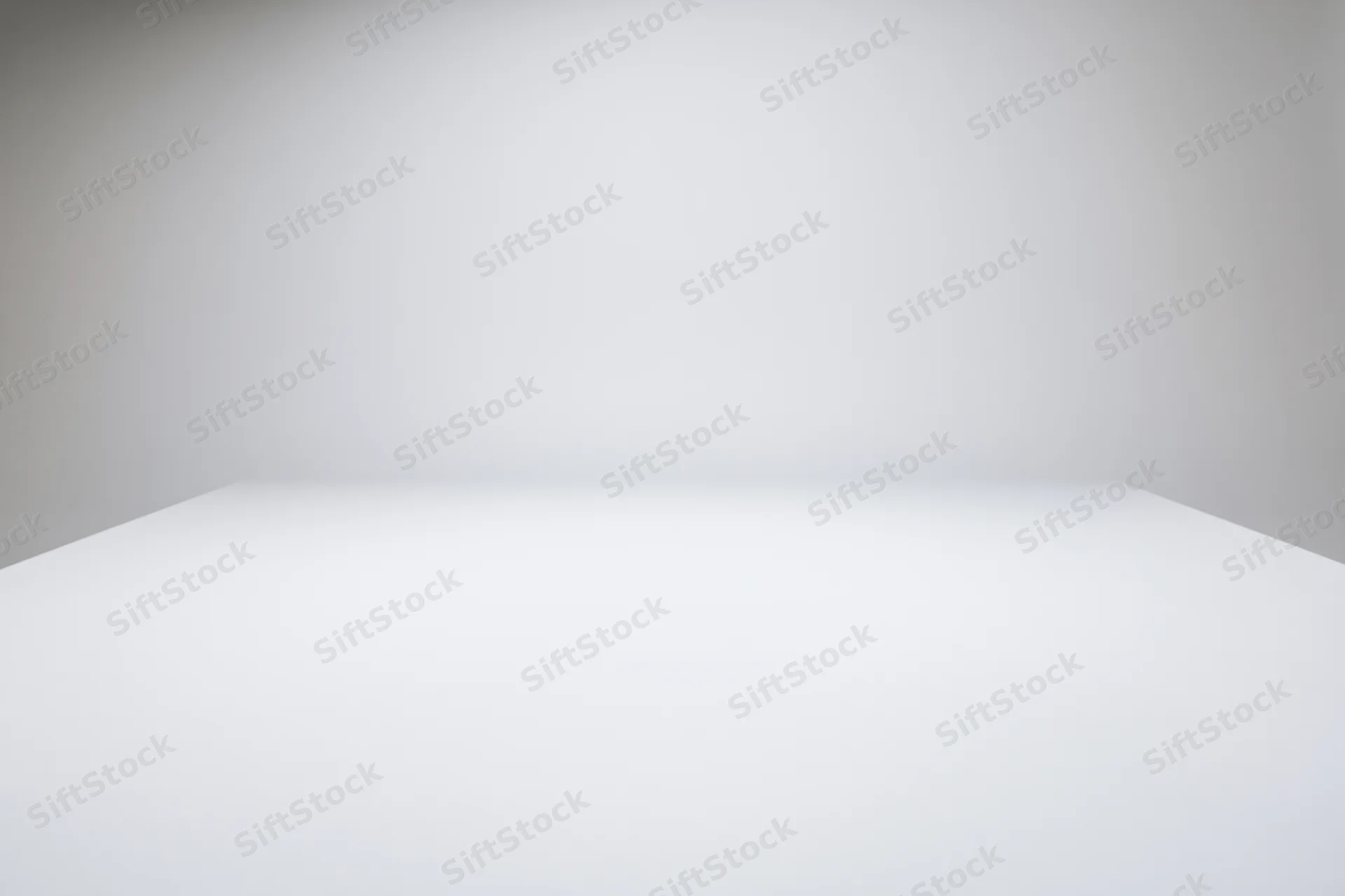 Empty white studio space with gradient background and copyspace for product display