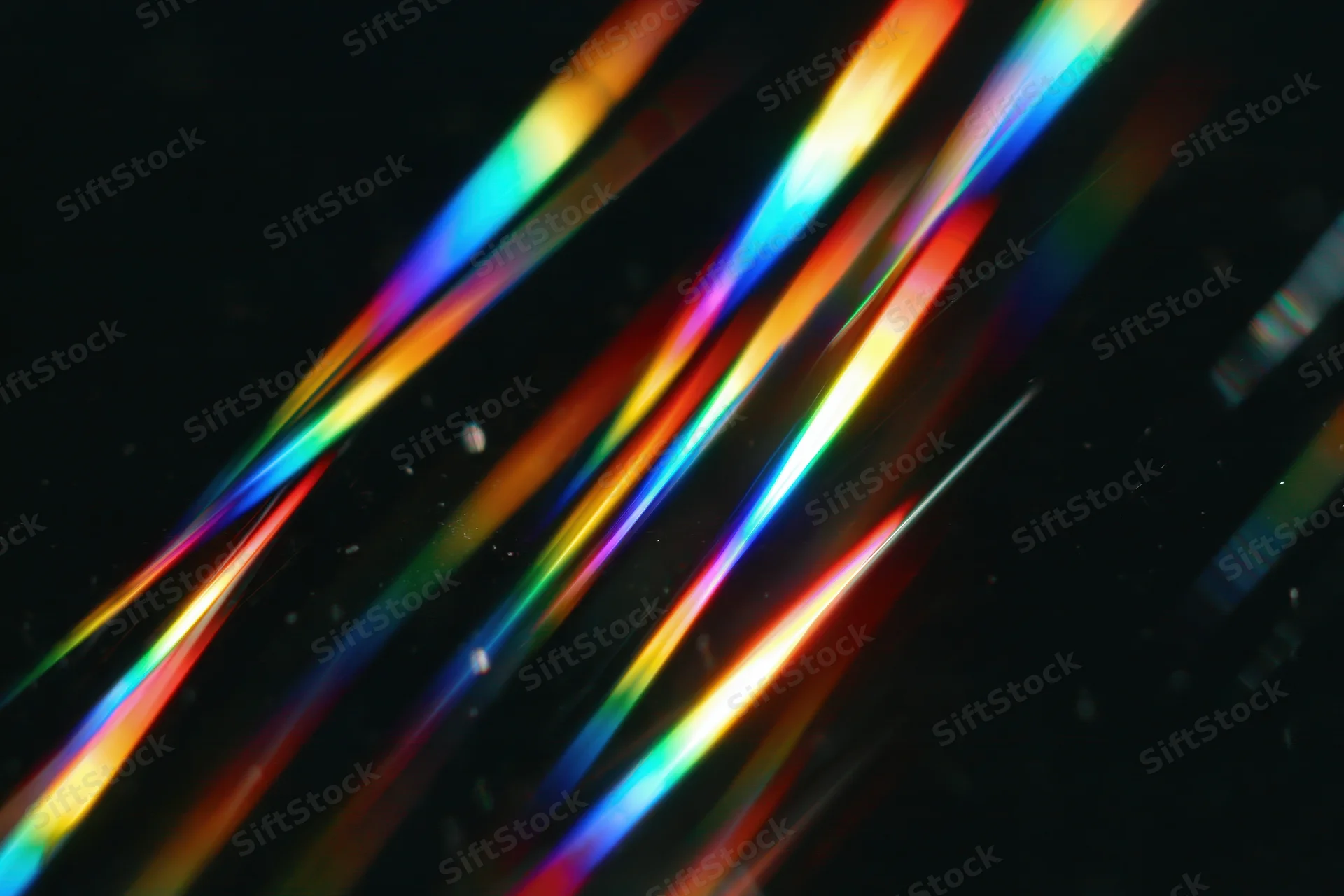 Prismatic light streaks scattered diagonally across dark background