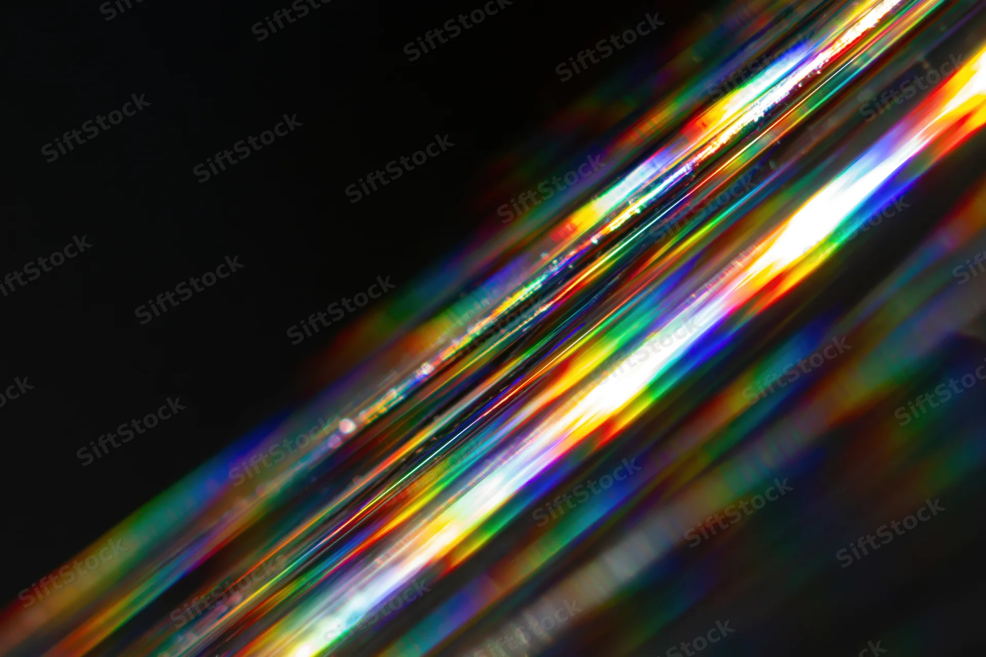 Prismatic light streaks scattered diagonally across dark background