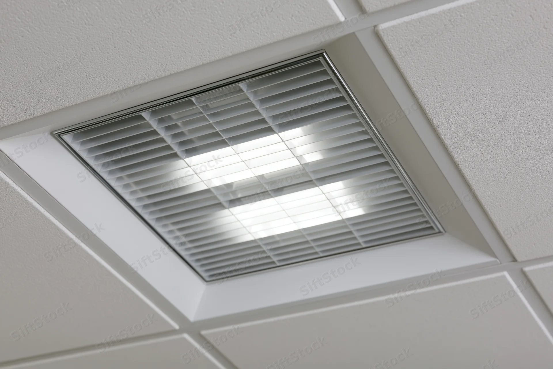 Recessed fluorescent grid light fixture mounted in a dropped ceiling tile system