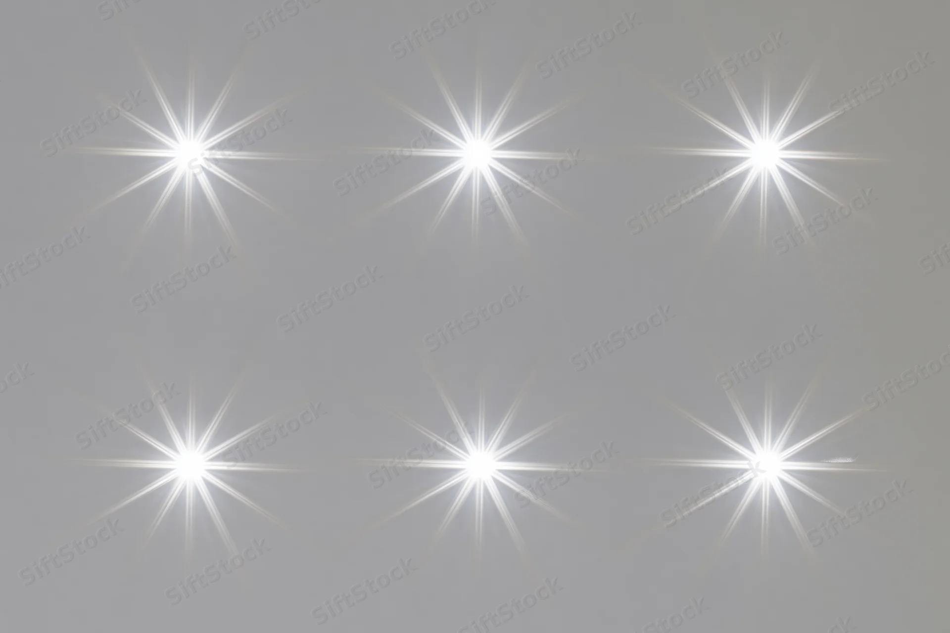 Six bright white lens flare star bursts arranged in two rows on a neutral gray background