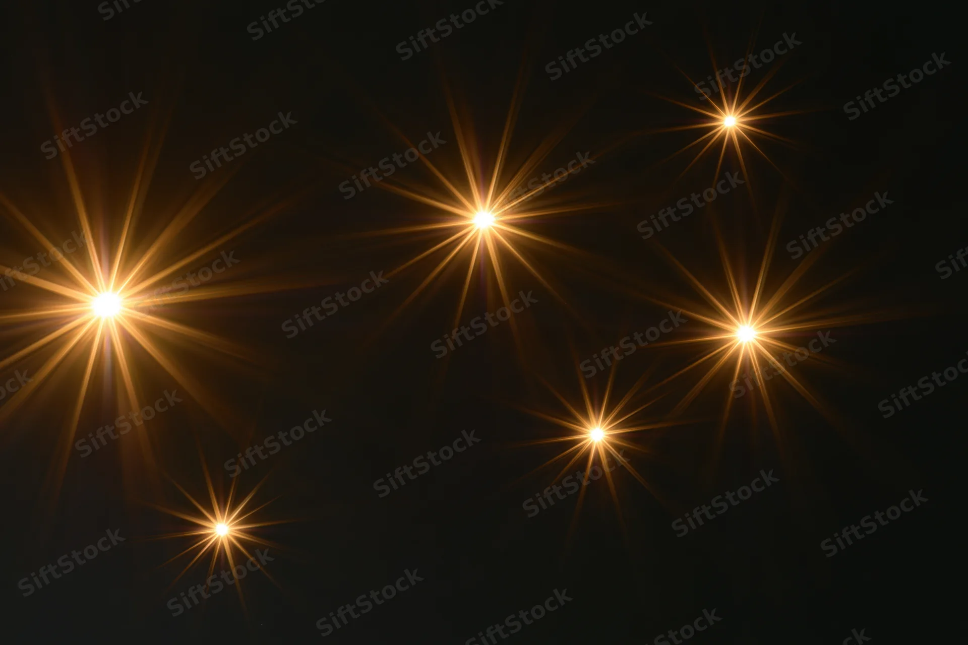 Six golden lens flare star bursts scattered across a dark background