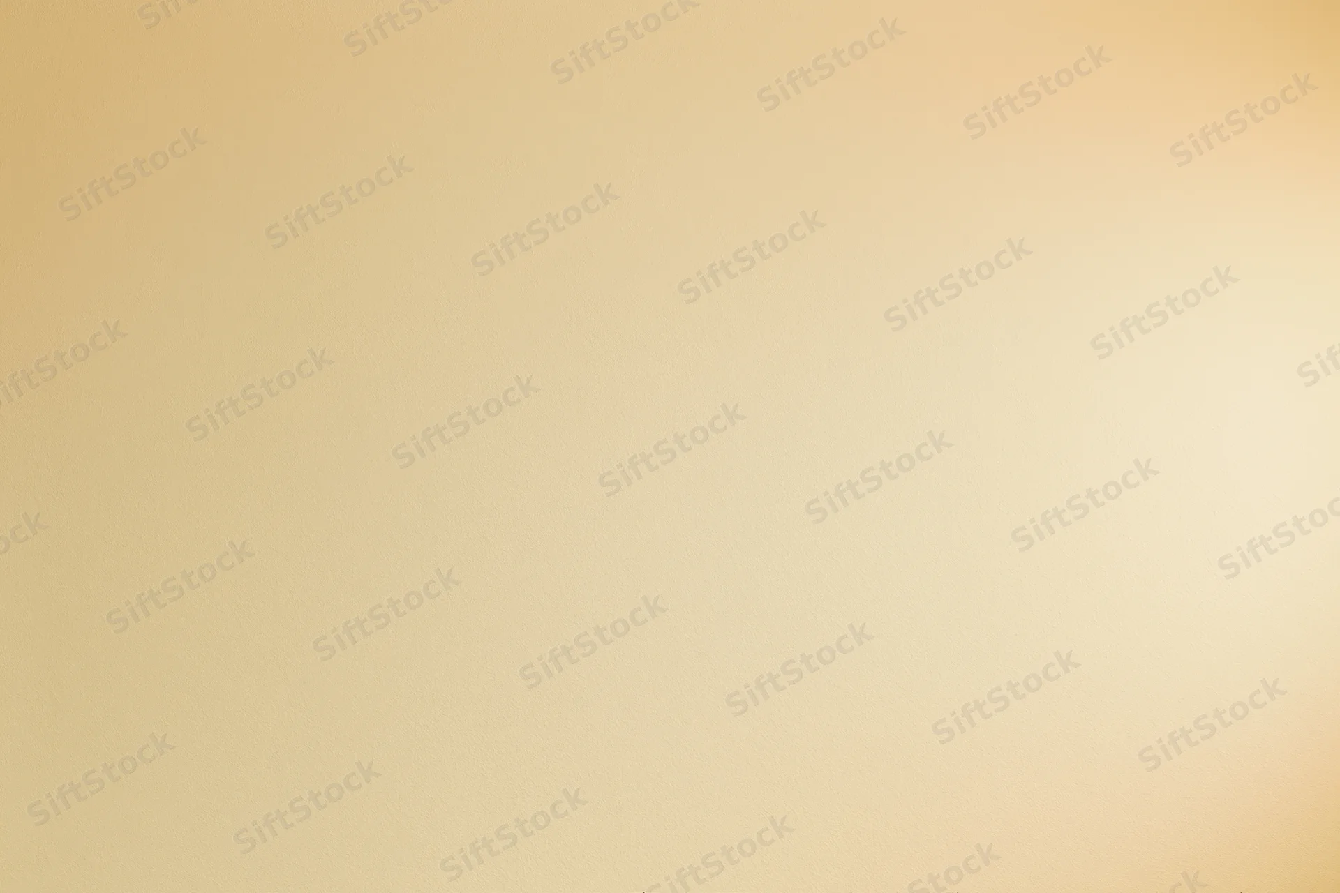 Smooth beige studio backdrop wall filling the frame with no subject or props