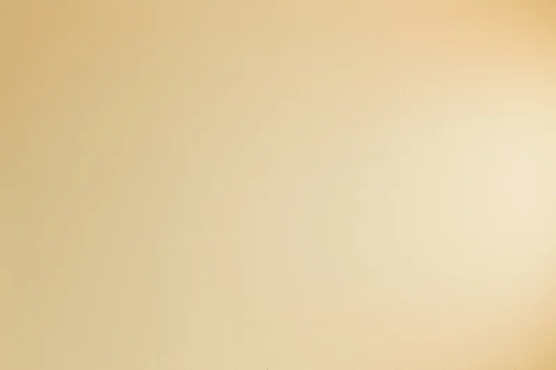 Smooth beige studio backdrop wall filling the frame with no subject or props