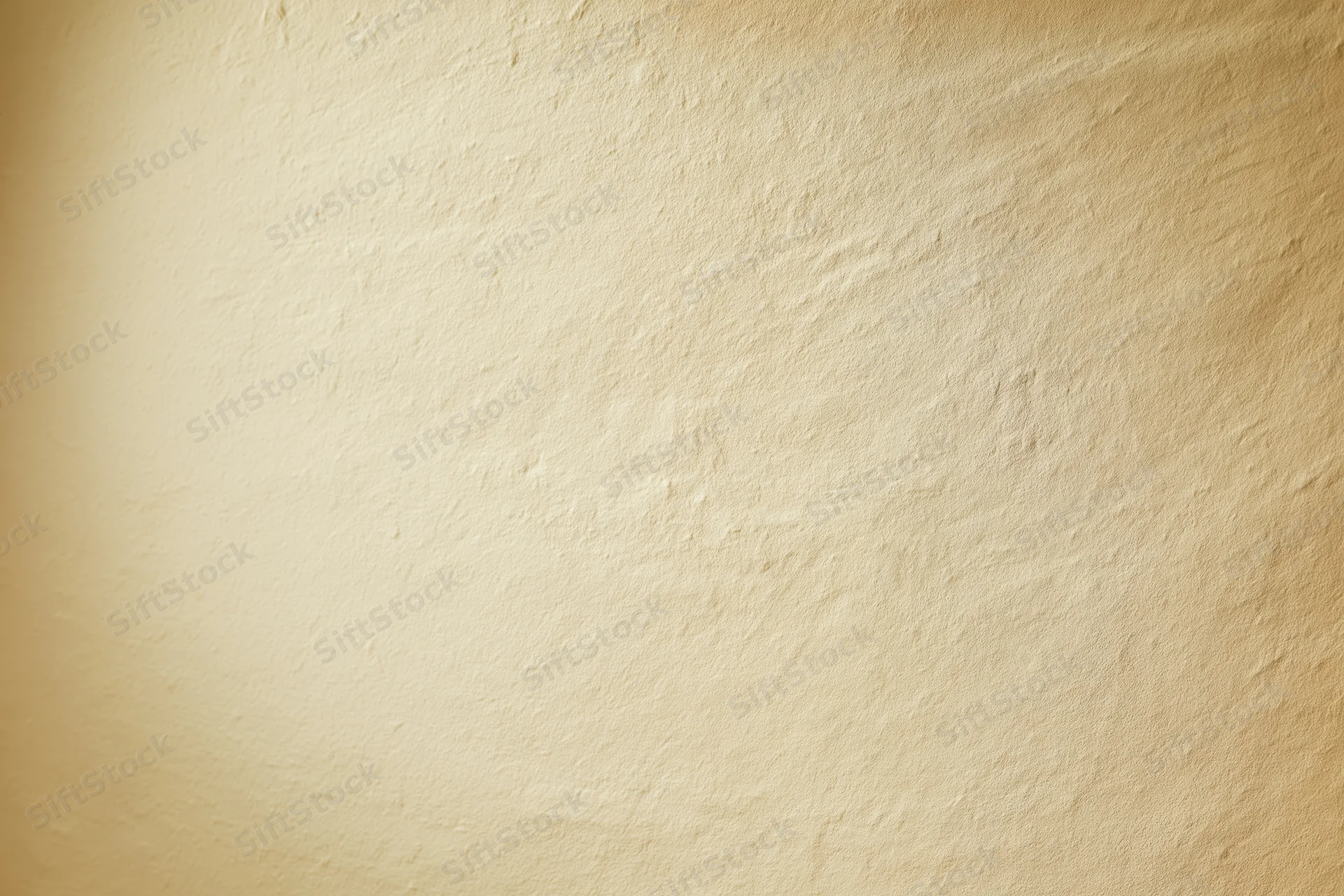 Smooth beige textured wall filling the frame as a studio backdrop