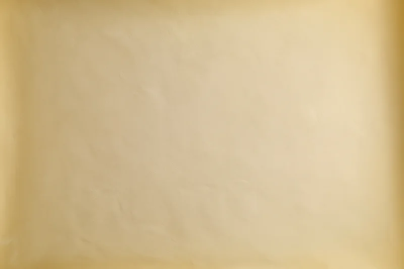 Smooth beige studio backdrop wall filling the frame with no subject or props