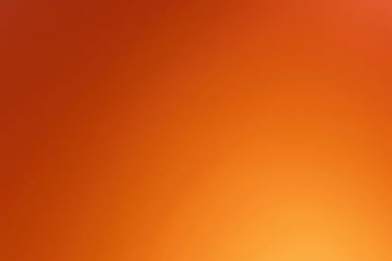 Smooth gradient background transitioning from deep red-orange to bright orange