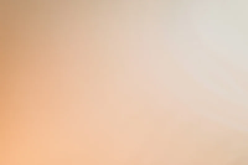 Smooth gradient background transitioning from warm peach to light orange