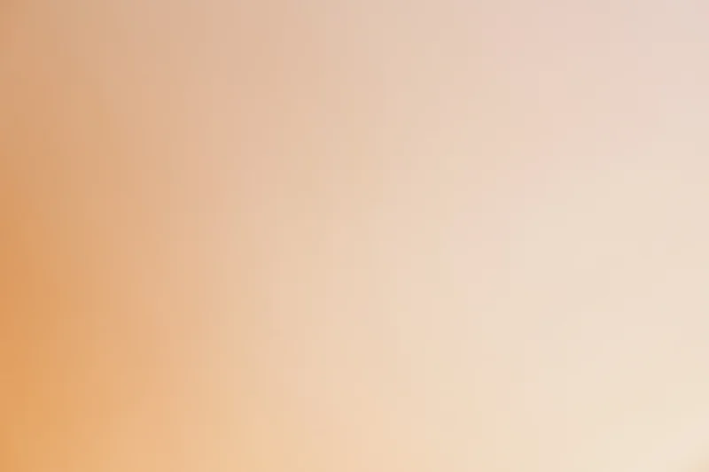 Smooth gradient background transitioning from warm peach to light orange