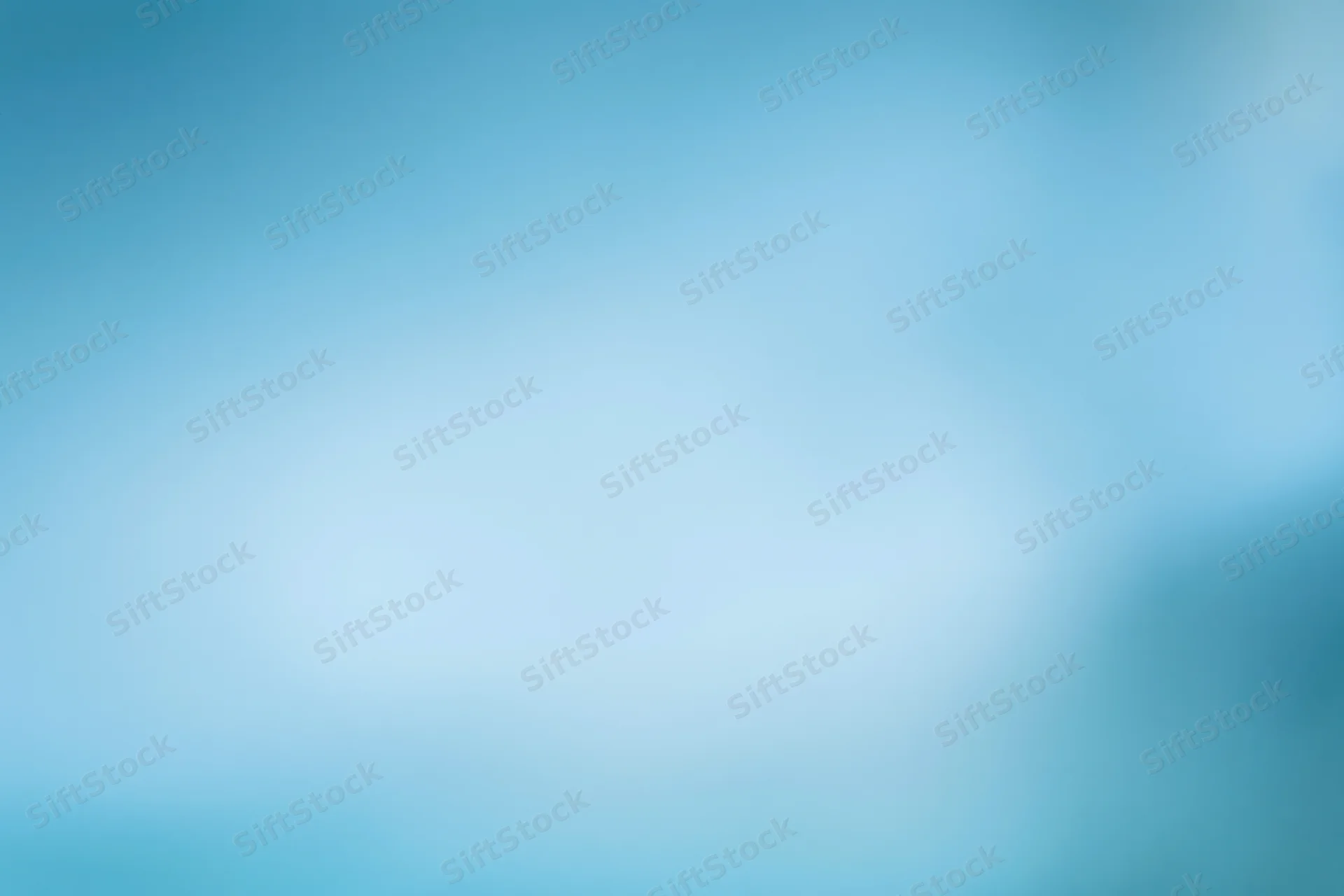 Smooth out-of-focus blue gradient background with soft light transitions