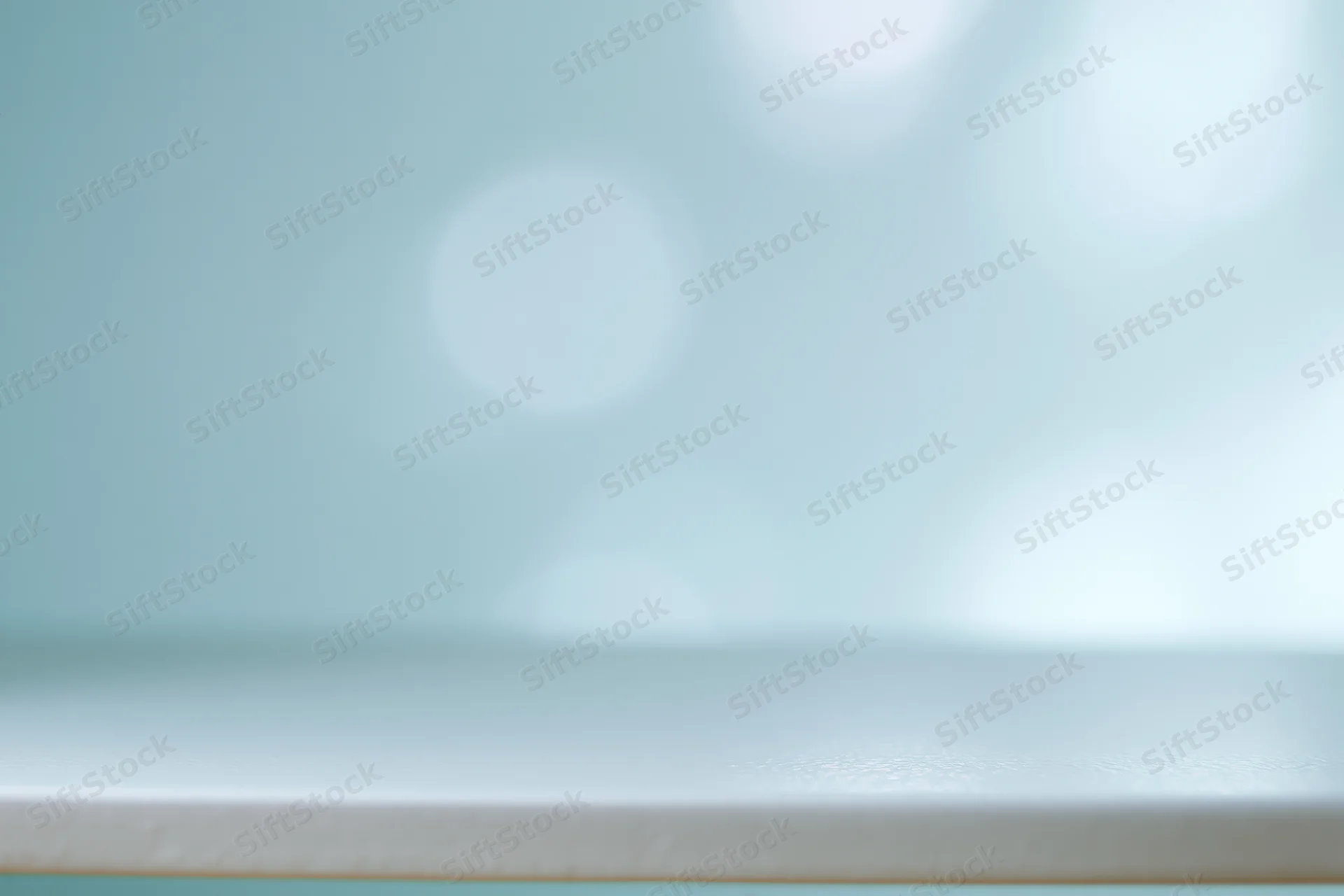 Soft abstract background with large defocused bokeh circles in pastel teal and white tones