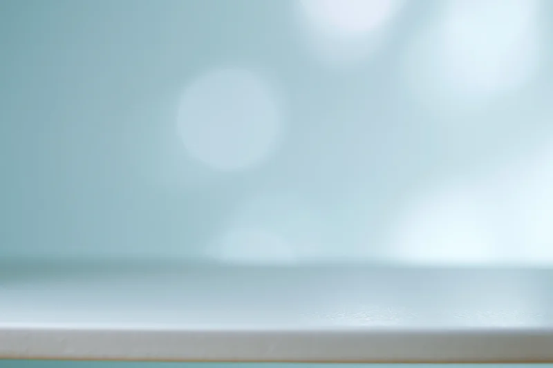 Soft abstract background with large defocused bokeh circles in pastel teal and white tones