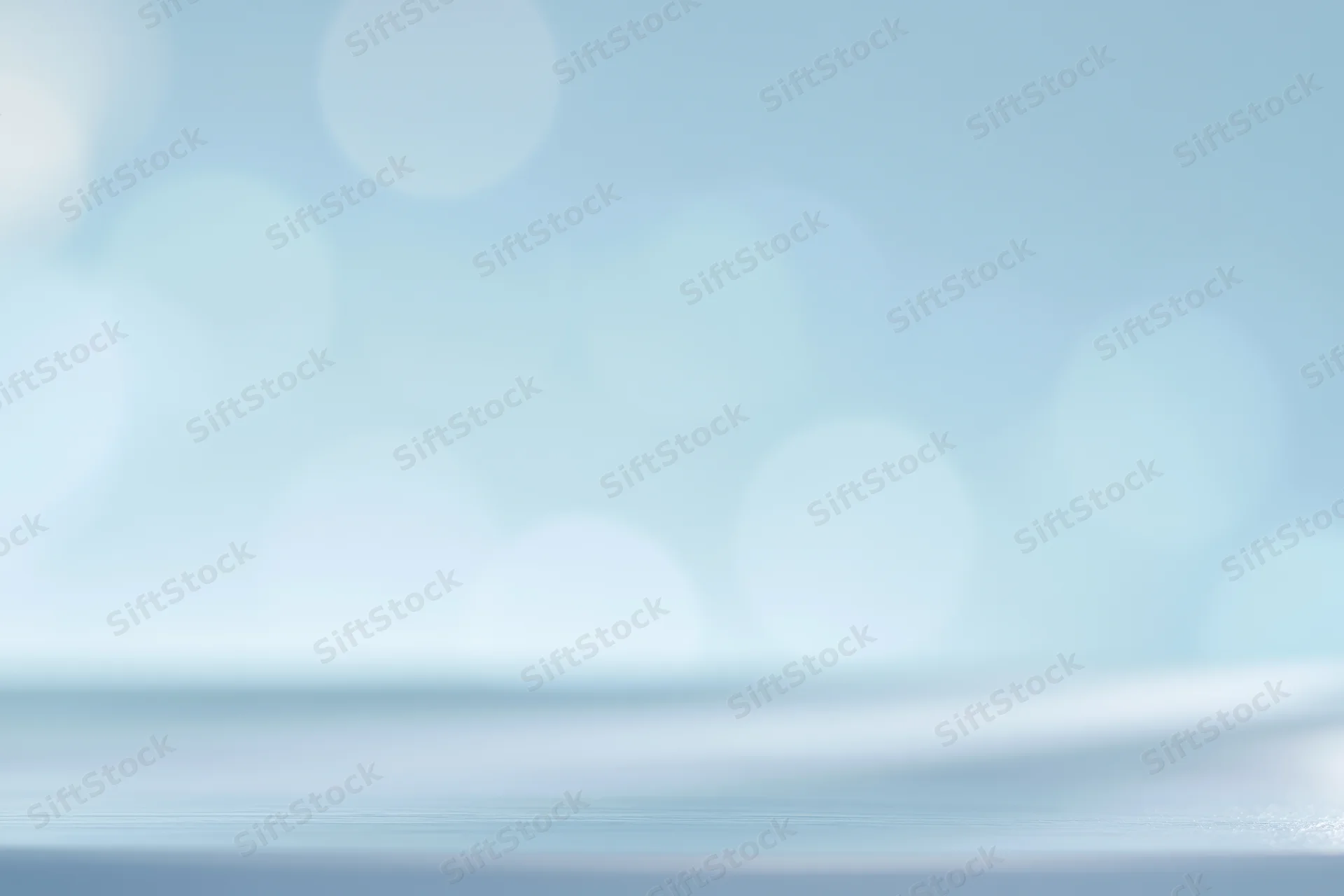 Soft abstract background with large defocused bokeh circles in pastel blue and white tones