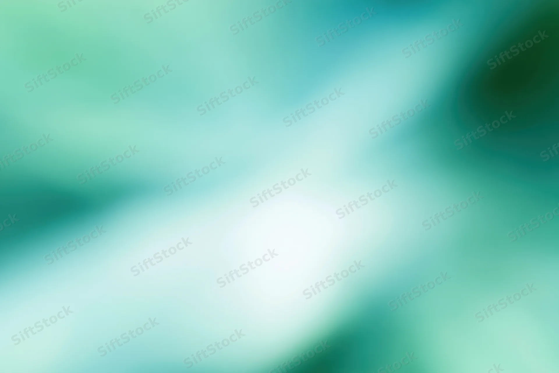Soft blurred abstract background with bright white center and teal green gradient