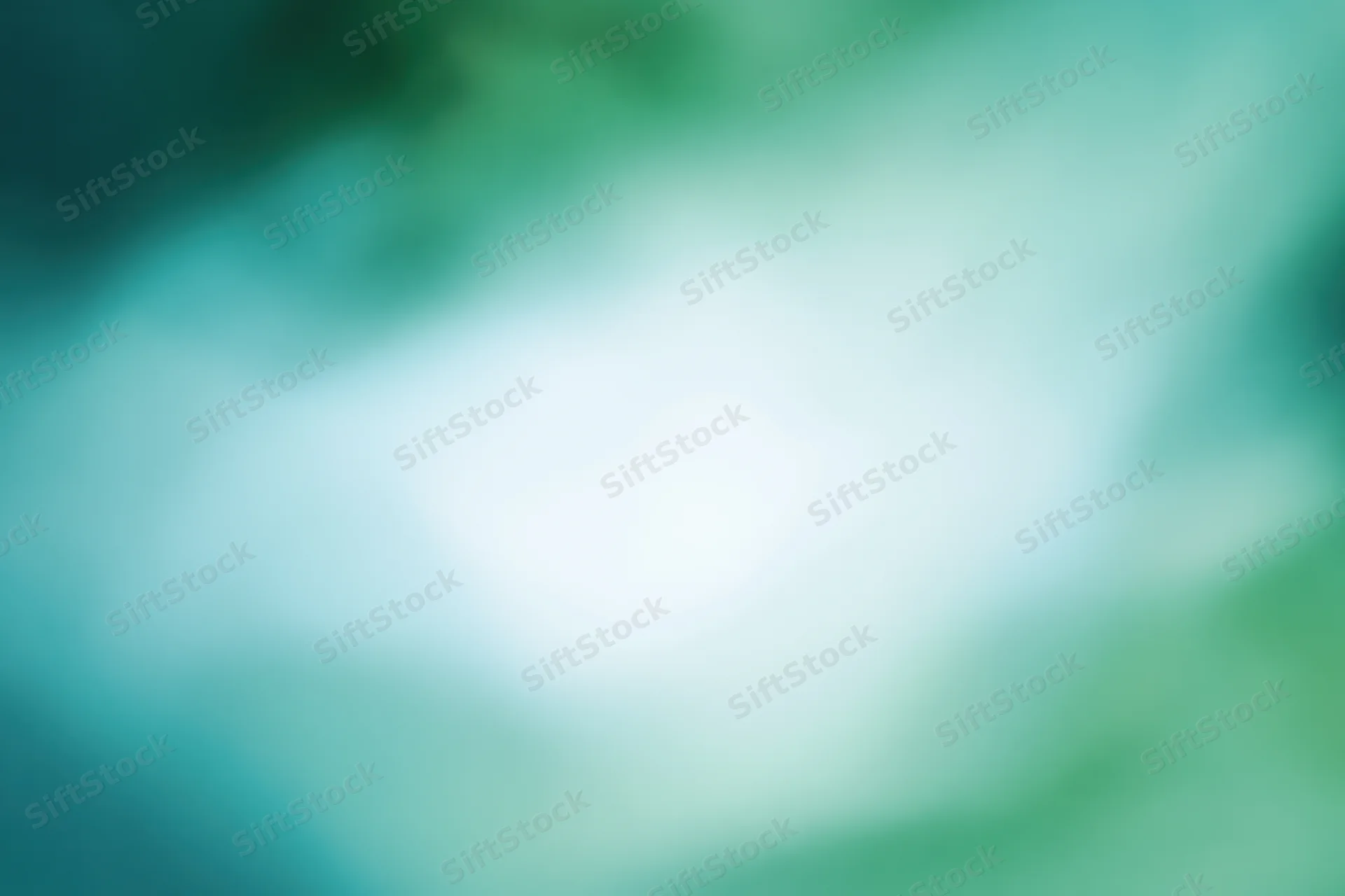 Soft blurred abstract background with bright white center and green teal gradient