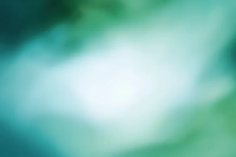 Soft blurred abstract background with bright white center and green teal gradient