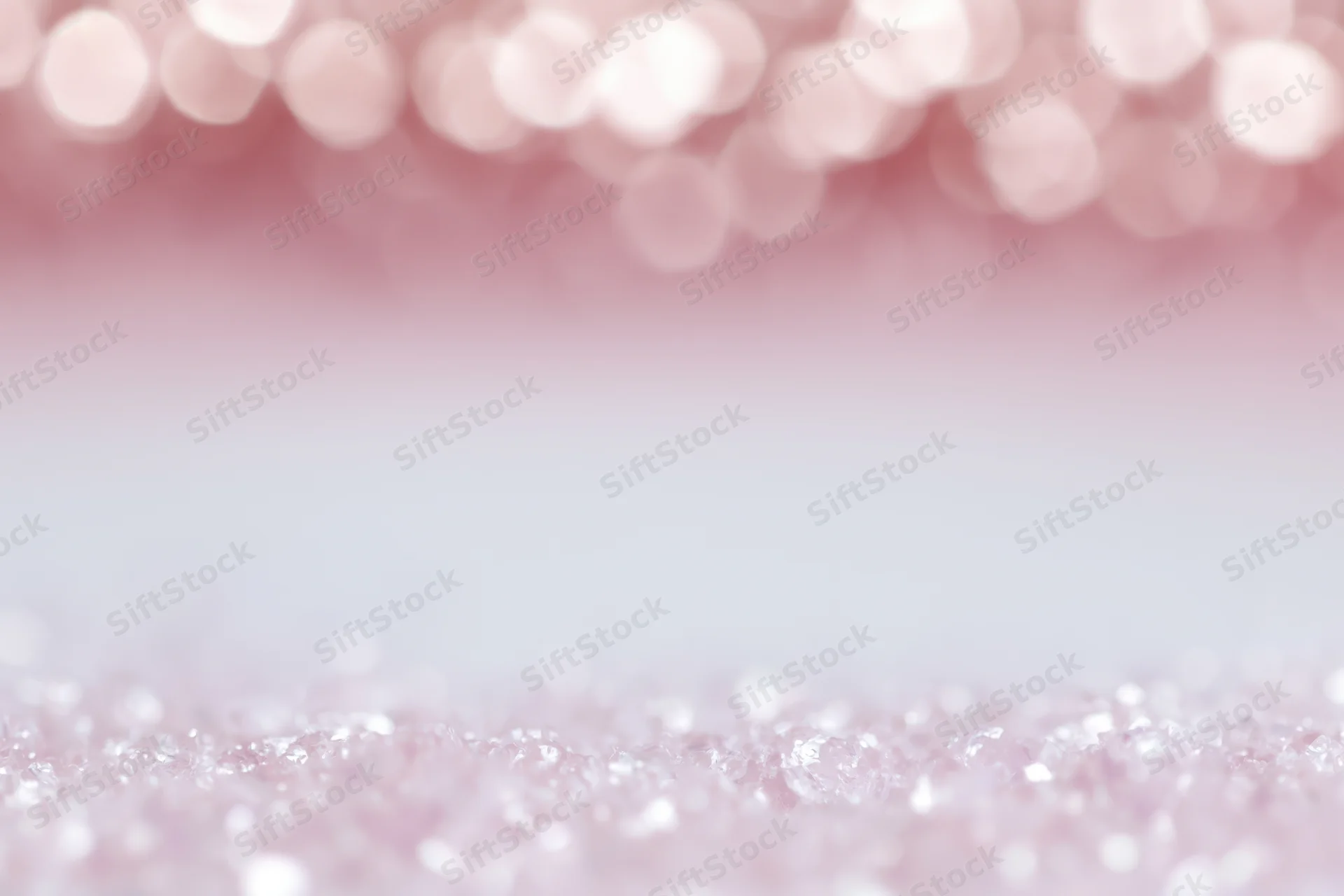 Soft pink bokeh background with out-of-focus light orbs and glittery texture, featuring copyspace in the center