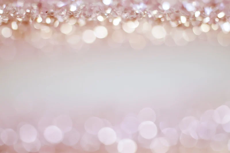 Soft abstract bokeh background with out-of-focus light orbs arranged in a frame border, leaving central copyspace