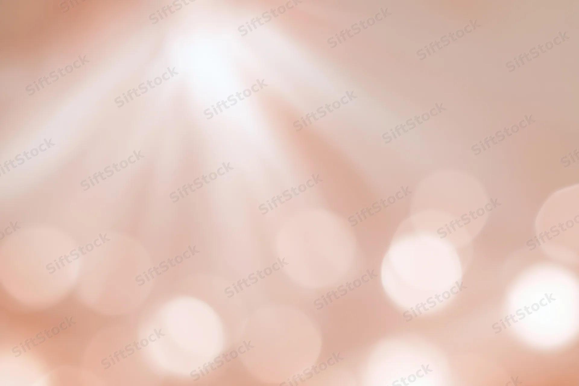 Soft blurred bokeh background with scattered circular lights in warm tones