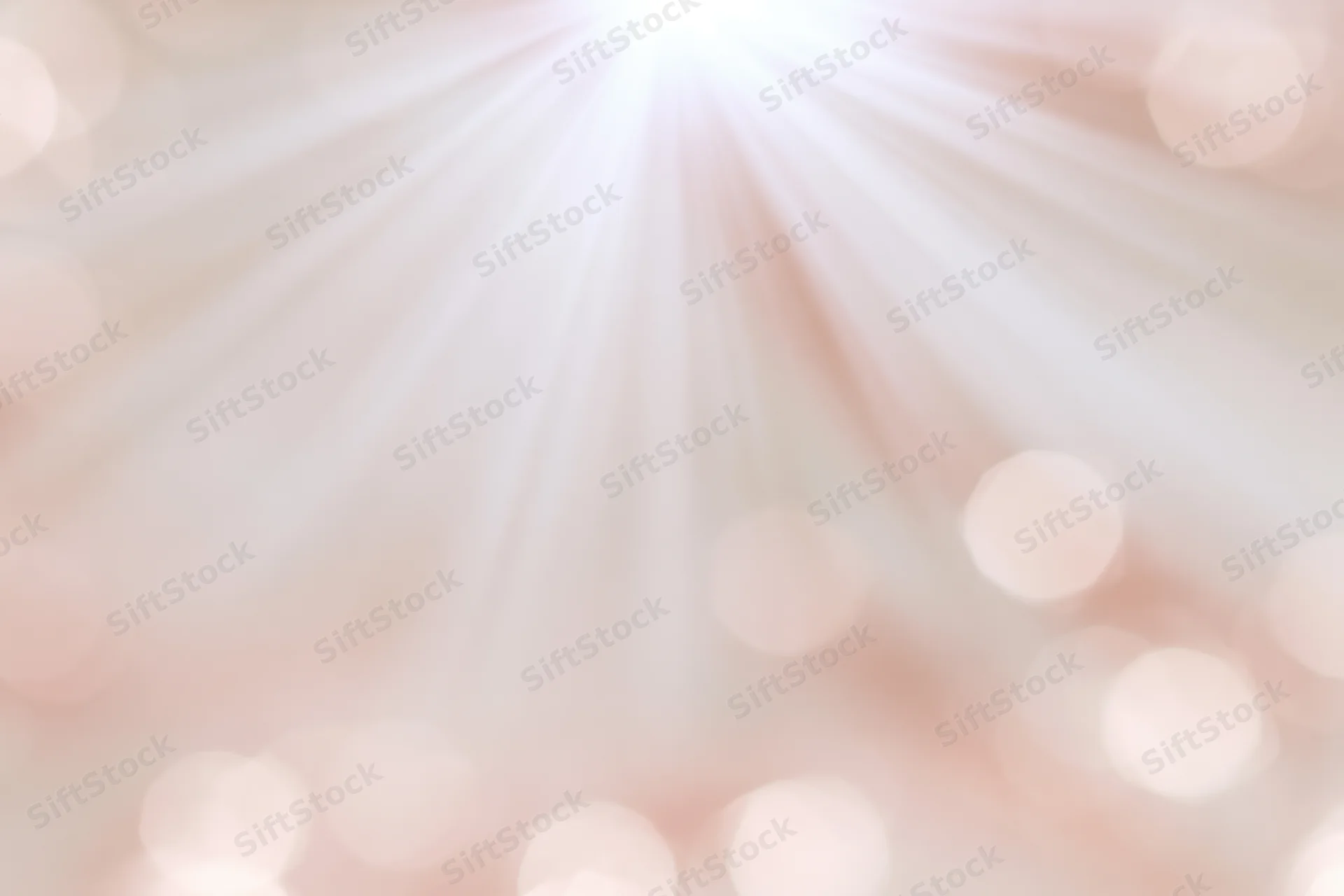 Soft blurred bokeh background with scattered circular lights in warm pastel tones
