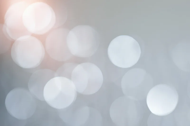 Soft out-of-focus light circles forming a blurred bokeh background with warm and cool tones