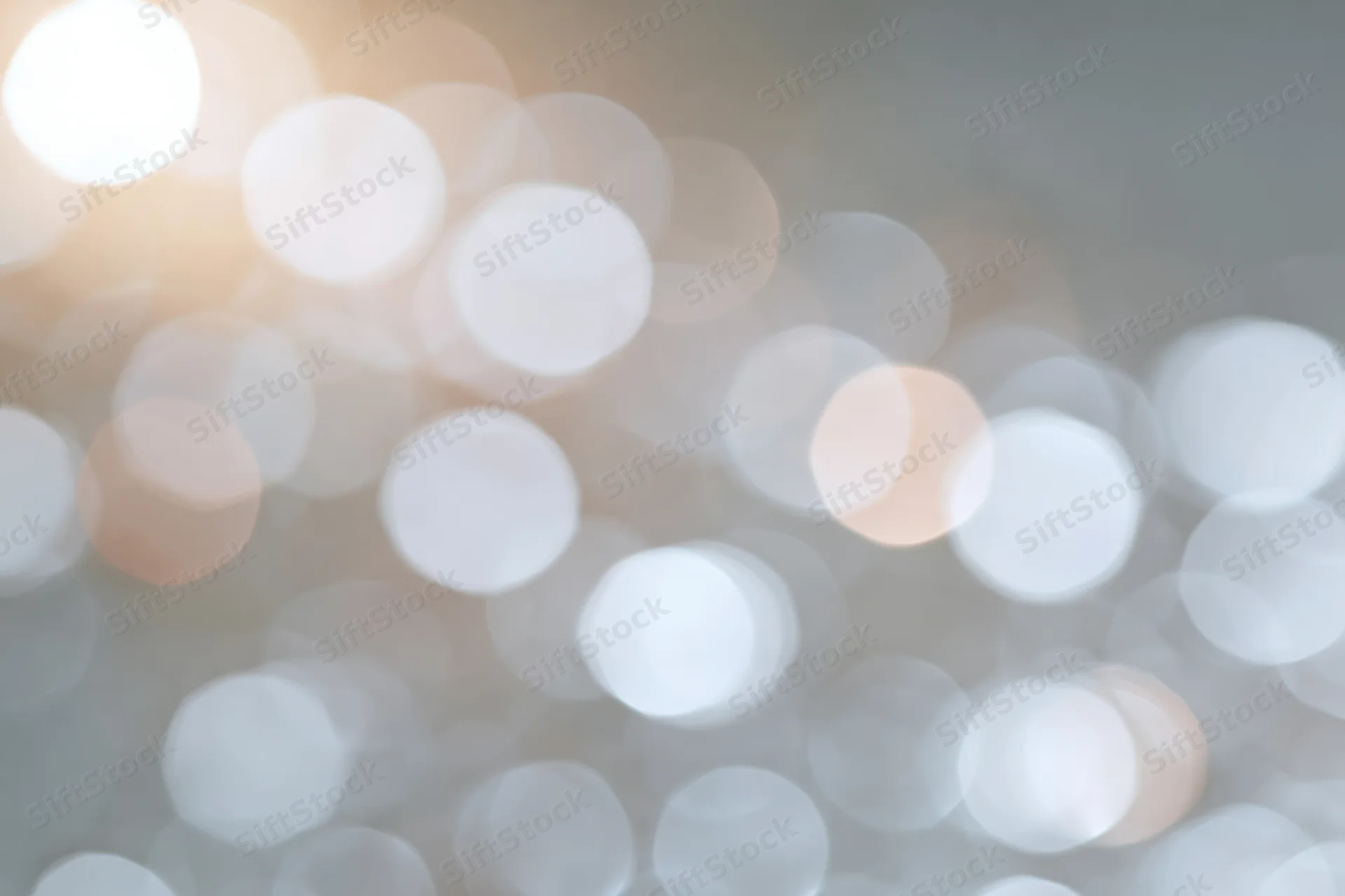 Soft out-of-focus light circles forming a blurred background with warm and cool tones