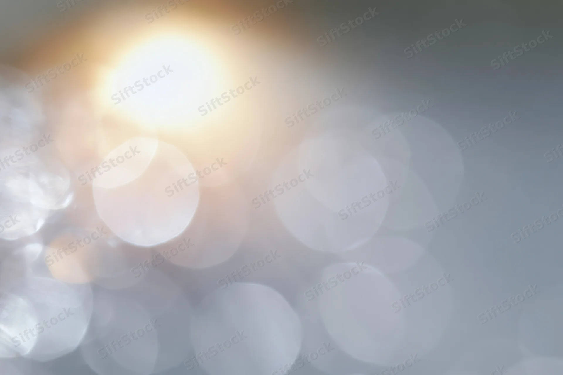 Soft out-of-focus light circles forming a blurred abstract background with warm and cool tones