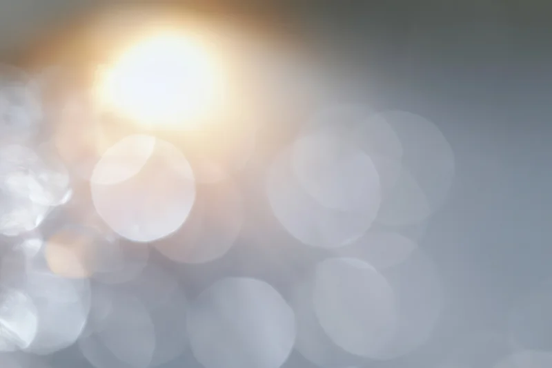 Soft out-of-focus light circles forming a blurred abstract background with warm and cool tones